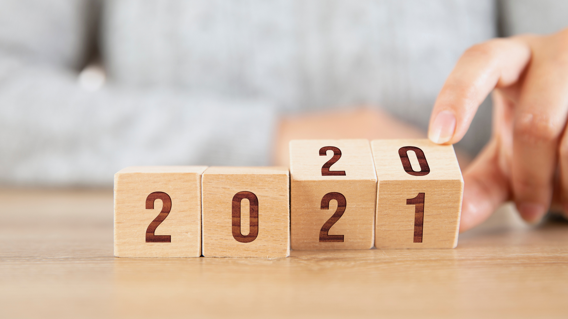 Wooden blocks with the year 2020 rotating to show the year 2021.